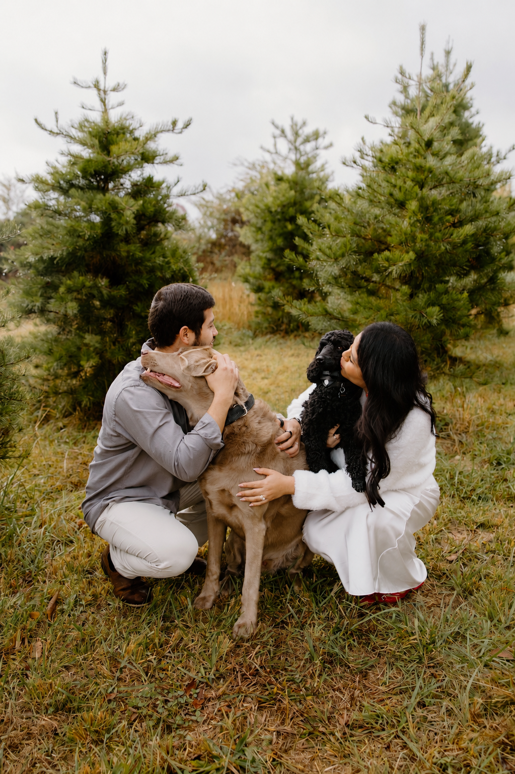 Chris and Salma Mejia, owners of Dirty Paws Groom n Go, with their Labrador and mini poodle
